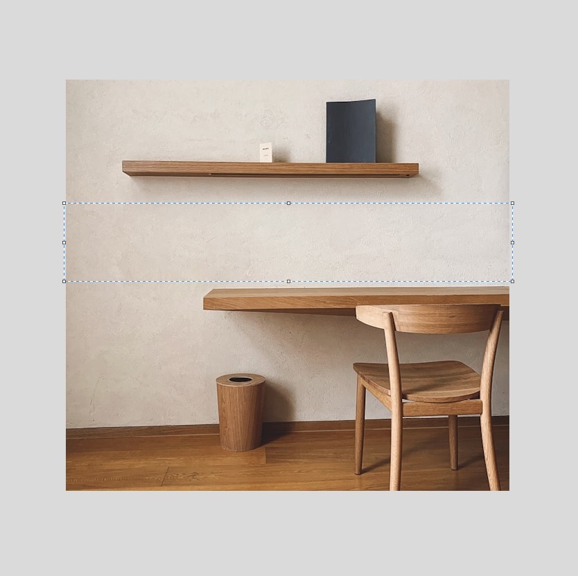 Negative space between a shelf and desk 